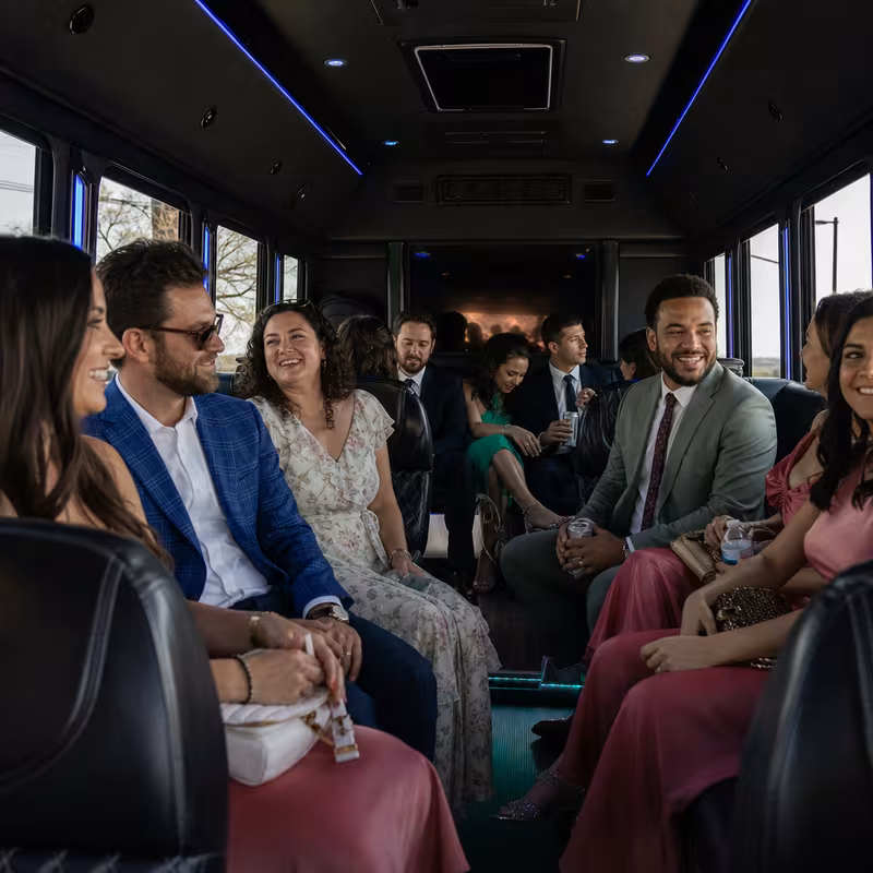Wedding guests seated inside a New Orleans party bus