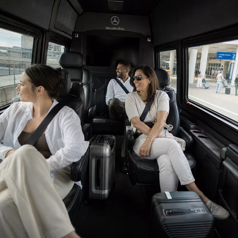 Passengers loading luggage while boarding an New Orleans group shuttle