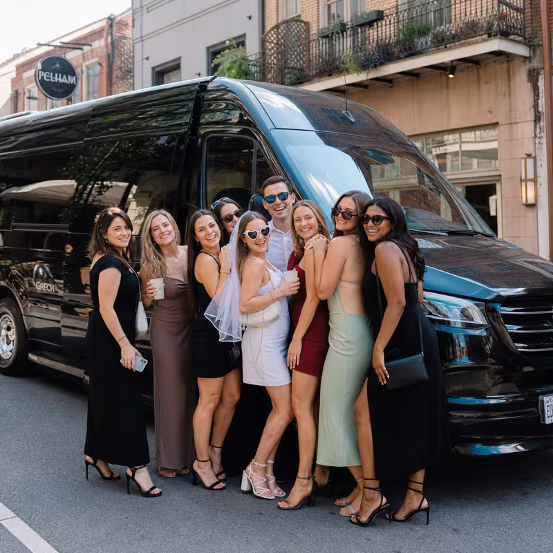 Group boarding a white charter bus for Bachelor & Bachelorette Transportation transportation in New Orleans