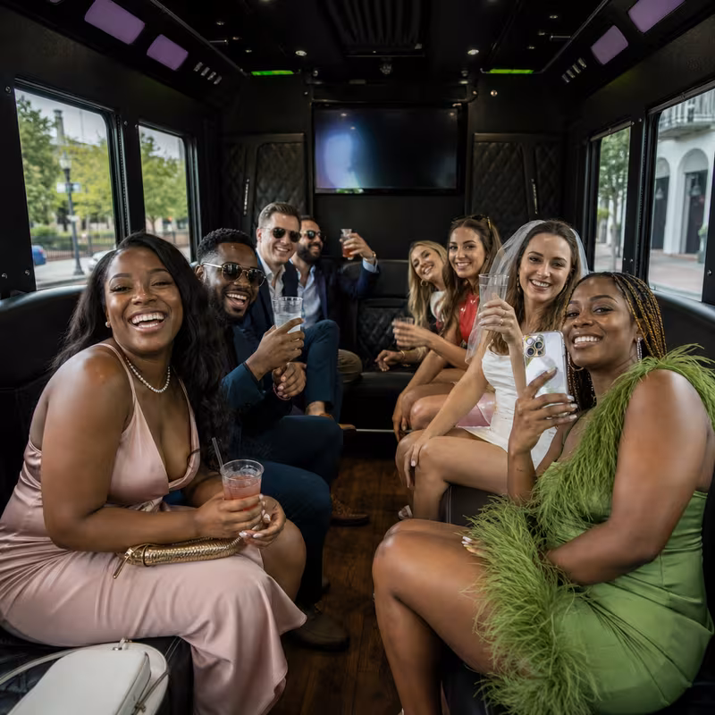 Party bus interior with wraparound leather seating and LED lighting in New Orleans