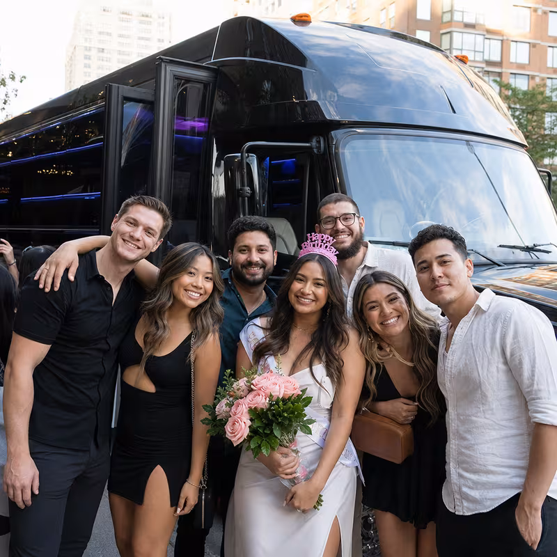 Group boarding a white charter bus for Birthday Transportation transportation in New Orleans