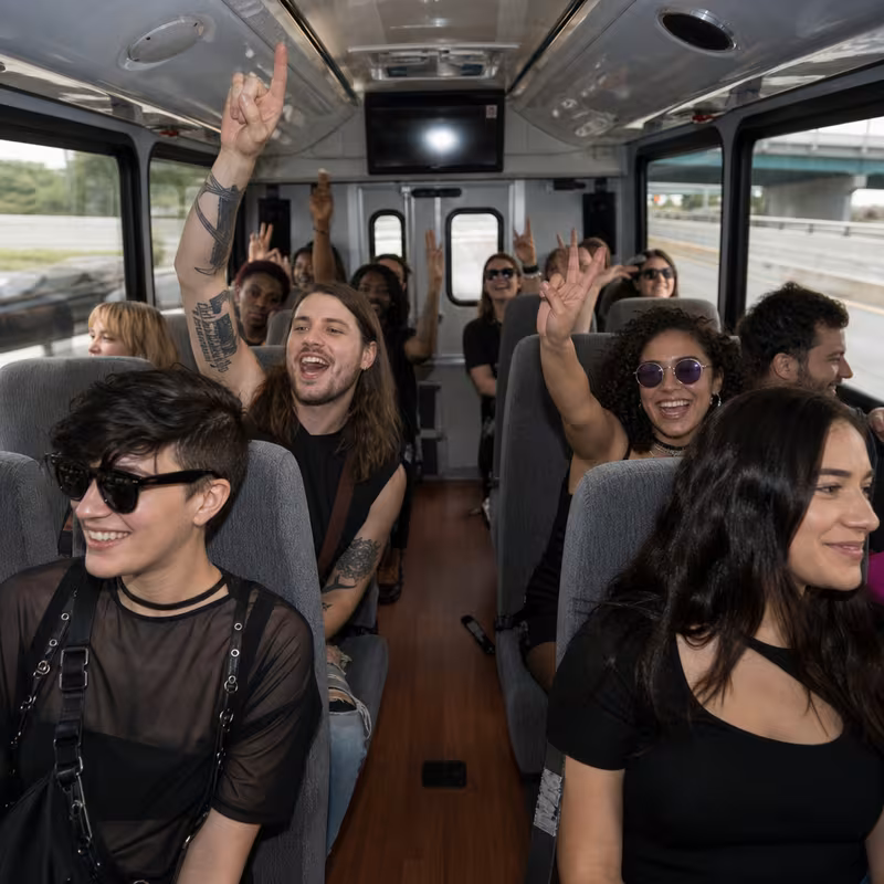 Party bus interior with wraparound leather seating and LED lighting in New Orleans
