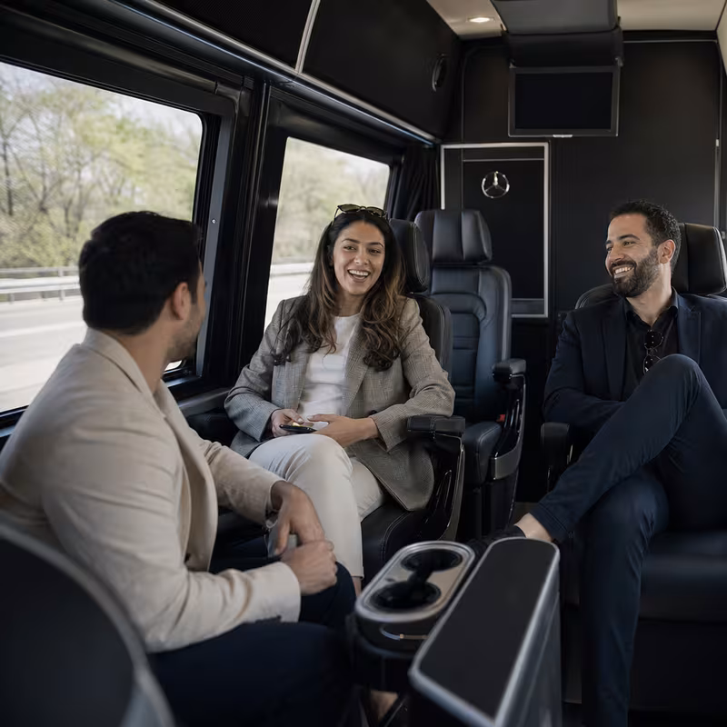 Group boarding a white charter bus for Corporate Transportation transportation in New Orleans
