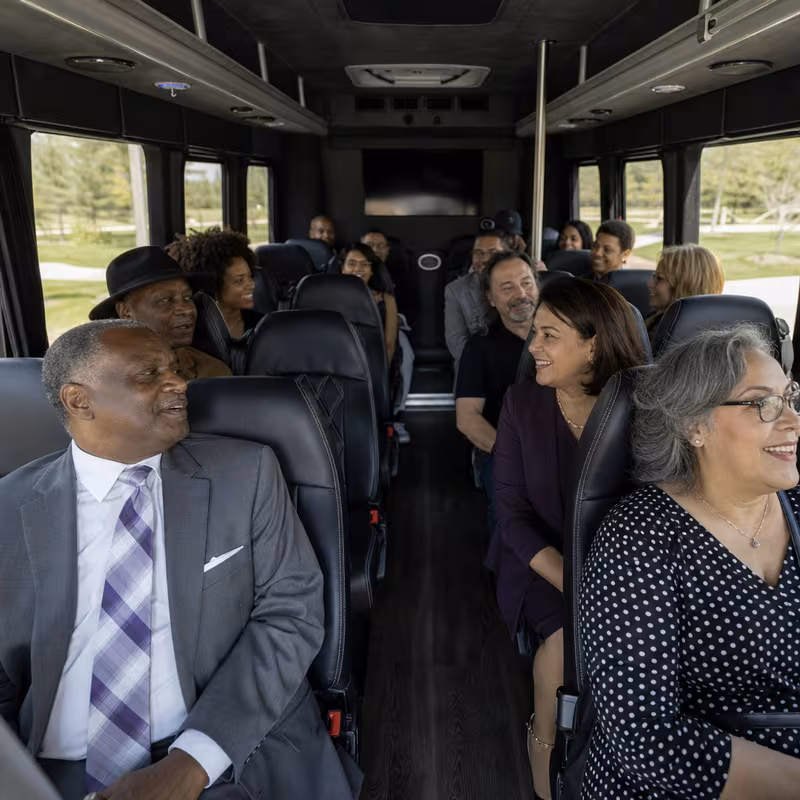 Group boarding a white charter bus for Private Event Transportation transportation in New Orleans