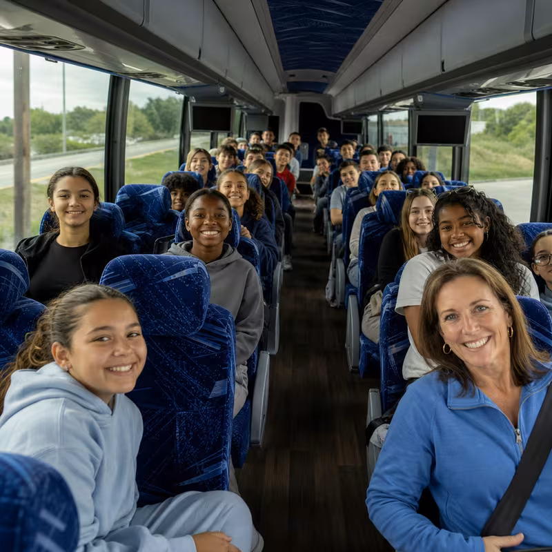 Group boarding a white charter bus for School Transportation transportation in New Orleans