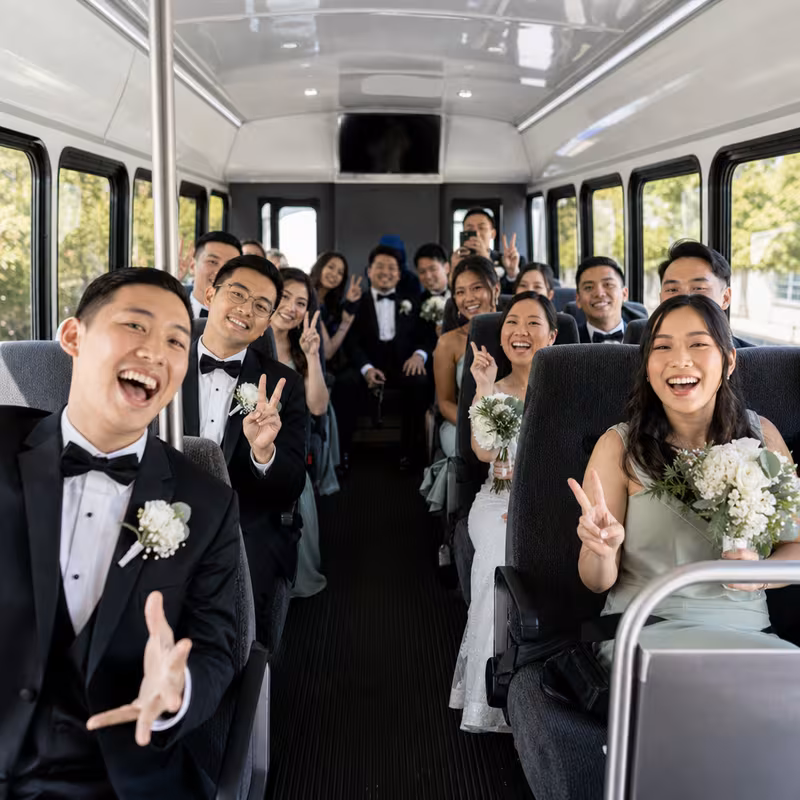 Group boarding a white charter bus for Wedding Transportation transportation in New Orleans