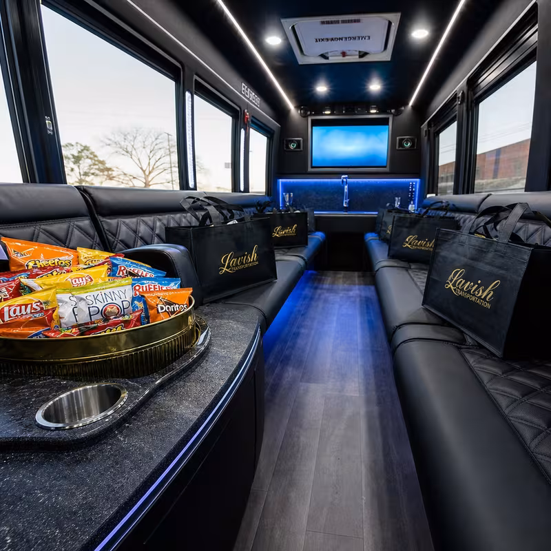 Party bus interior with wraparound leather seating and LED lighting in New Orleans